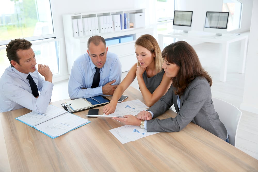 Business owners discussing a business ownership and succession plan Business owners discussing a business ownership and succession plan