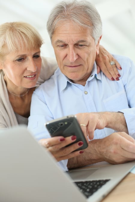 Older couple reviewing their life insurance policy and financial options.
