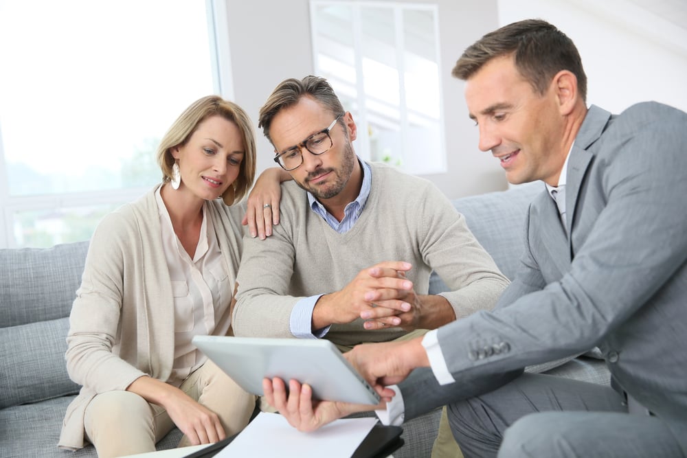 Business owners reviewing financial documents with an advisor