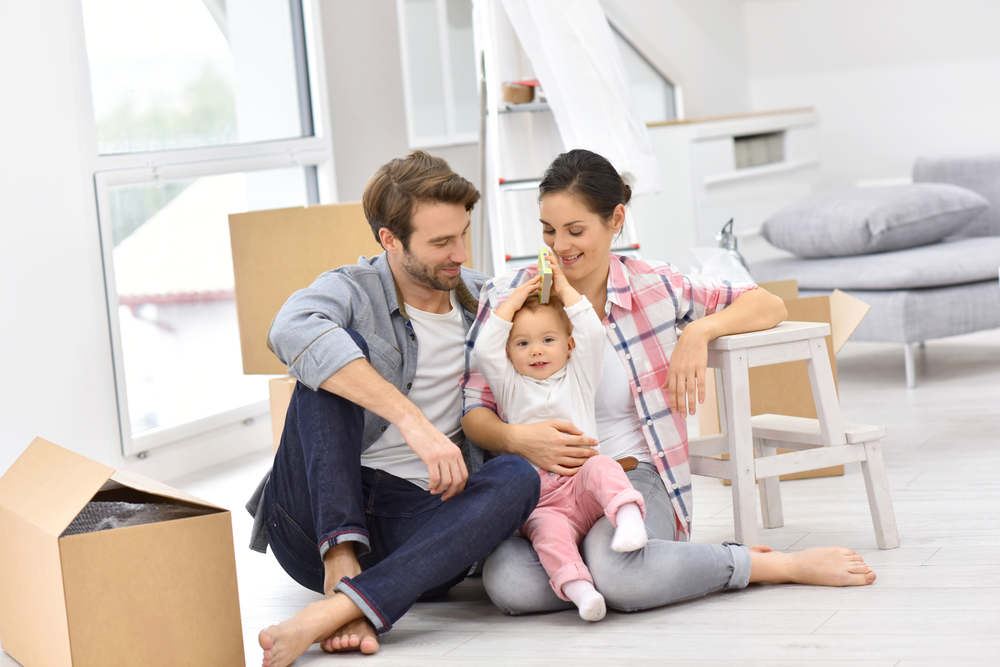 Young family with a baby moving into their new home Young family with a baby moving into their new home
